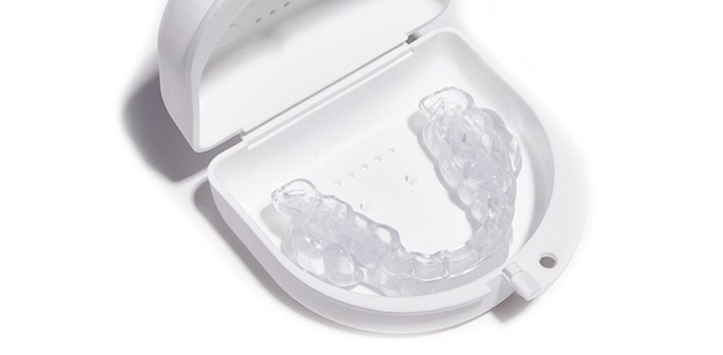 Clear aligners placed in a container white color