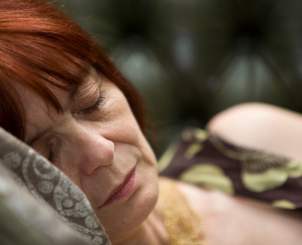Elder woman sleeping in a bed
