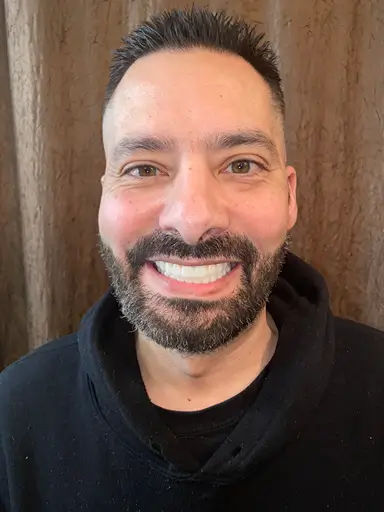 client smilling after surgery