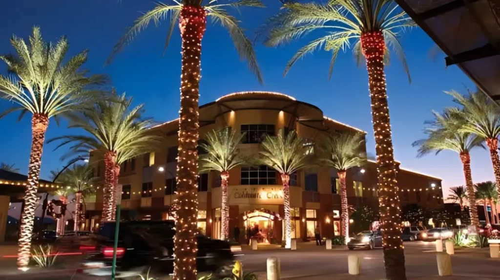 image of a hotel outside with palms at night