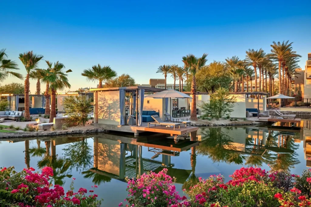 hotel picture of a pool with cabins and sunbeds